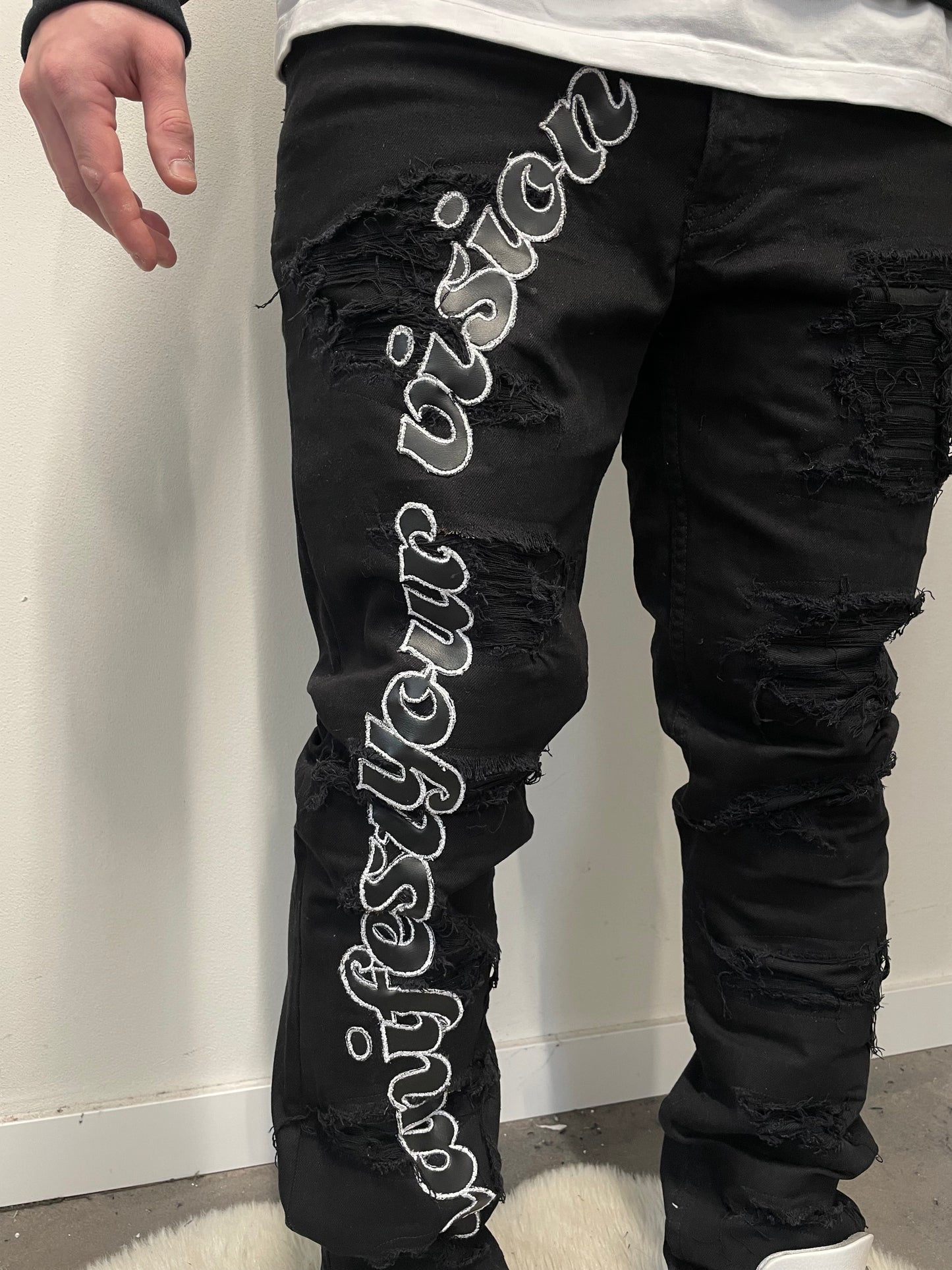 Black distressed jeans manifest your vision